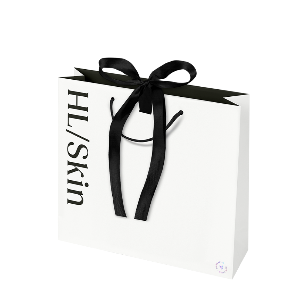 HL/Skin Premium Gifting Bag Large, white matte paper gift bag with black ribbon handles and HL/Skin logo
